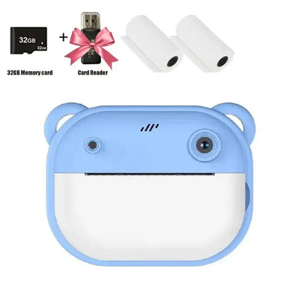 Blue children's digital camera with bear design, 32GB memory card, card reader, and printing paper rolls.